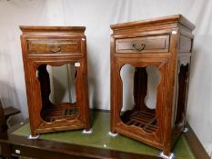 A pair of teak jardiniere stands