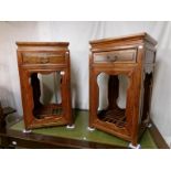 A pair of teak jardiniere stands