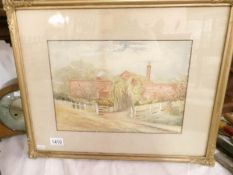A framed and glazed watercolour of farm buildings