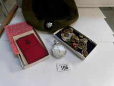 A military stop watch, badges,