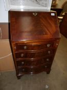 A small mahogany serpentine front ladies bureau