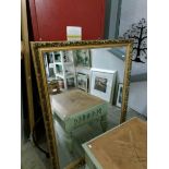 A large gilt framed mirror featuring Dahlia,