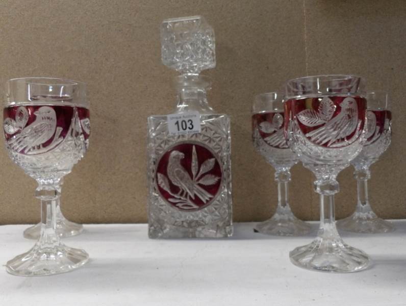 A glass decanter with red glass overlay,