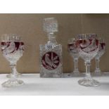 A glass decanter with red glass overlay,