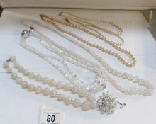 3 pearl necklaces (one with silver clasp), 2 'vaseline' glass necklaces,