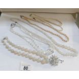 3 pearl necklaces (one with silver clasp), 2 'vaseline' glass necklaces,