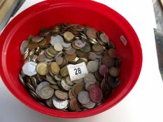 A tin of mixed UK and foreign coins