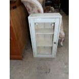 A shabby chic green painted glazed wall cabinet