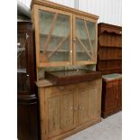 A pine glazed top cupboard