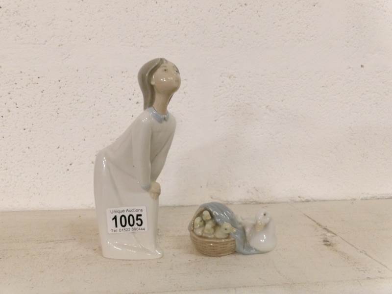 A Lladro figurine and  a Lladro ducks group