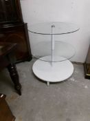 A circular glass shop display stand