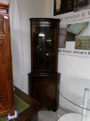 A mahogany corner cabinet