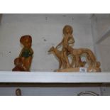 An Art Deco plaster figurine with dogs and a plaster figure of a boy