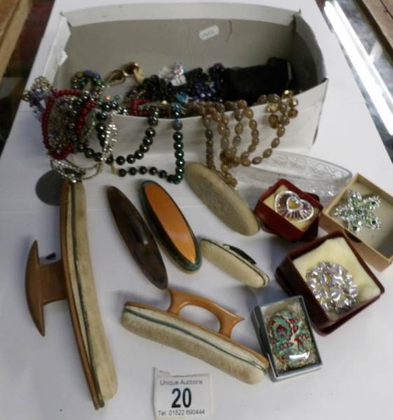 A box of costume jewellery including nail buffers