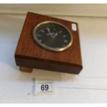 A Jaeger car clock mounted in wood,