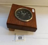 A Jaeger car clock mounted in wood,