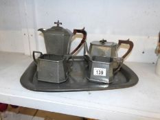 A 4 piece hammered pewter tea set on tray