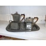 A 4 piece hammered pewter tea set on tray