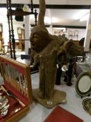 A large tree root carving with face,