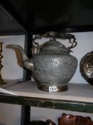 A large metal middle eastern teapot