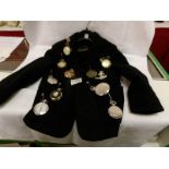 10 pocket watches attached to a child's blazer