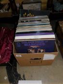 A box of LP records mainly musicals and easy listening