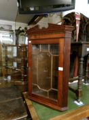 A mahogany corner wall cabinet