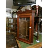 A mahogany corner wall cabinet