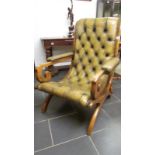 A green leather deep buttoned arm chair