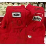 A pair of McLaren Pit Stop overalls signed by Michael Schumaker, Lewis Hamilton, Niki Lauder,