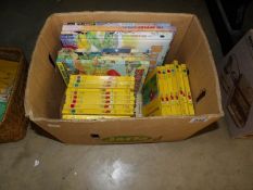 A box of Rupert books and annuals