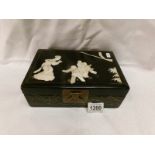 An Oriental lacquered jewellery box inlaid with mother of pearl and a quantity of polished stone