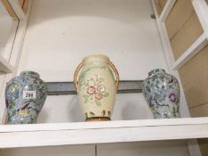 A pair of vases and one other