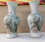 A pair of Victorian style glass vases decorated with birds
