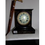 A cast iron mantel clock by the Ansonia Clock Co.