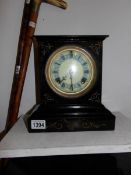 A cast iron mantel clock by the Ansonia Clock Co.