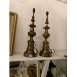 A pair of spelter table lamps with patinated brass finish