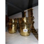 A pair of Victorian brass candlesticks and a pair of brass jugs