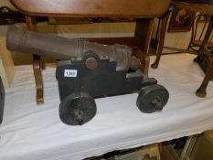 A large model cannon on wooden carriage