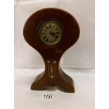An Art Nouveau mahogany inlaid mantel clock