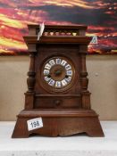 A Victorian/Edwardian clock with pendulum and key