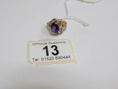 A 9ct gold ring set fine African amethyst and small diamonds in flower head setting,