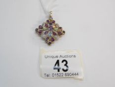 A 9ct gold pendant set multi gem stones