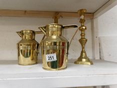 A pair of Victorian brass jugs and a pair of Victorian brass candlesticks