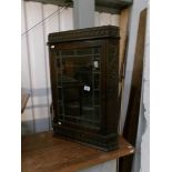 A late 19th century carved oak hanging corner cabinet