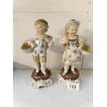A pair of late 19th century boy and girl figures