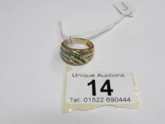 A 9ct gold ring with channel set emeralds,