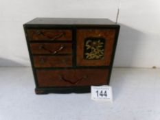 An Oriental lacquered jewel cabinet