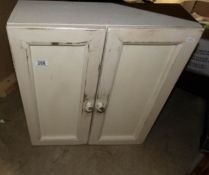 A painted wall cupboard