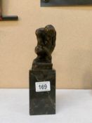 A bronze figure 'The Thinker' on marble plinth